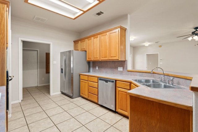 kitchen featuring sink, ceiling fan, backsplash, stainless steel appliances, and light tile patterned flooring