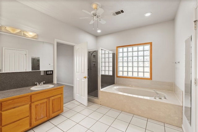 bathroom with ceiling fan, vanity, shower with separate bathtub, and tile patterned flooring