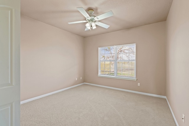 carpeted empty room with a textured ceiling and ceiling fan