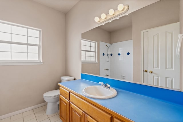 bathroom featuring vanity, tile patterned flooring, toilet, and tiled shower