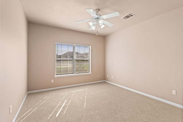 spare room with carpet floors, a textured ceiling, and ceiling fan