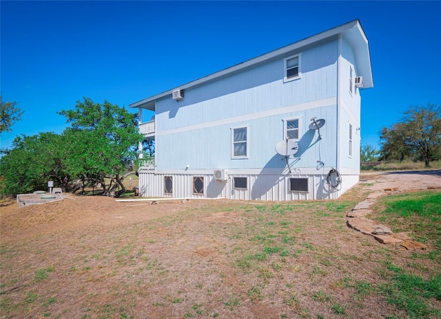 rear view of property featuring a yard