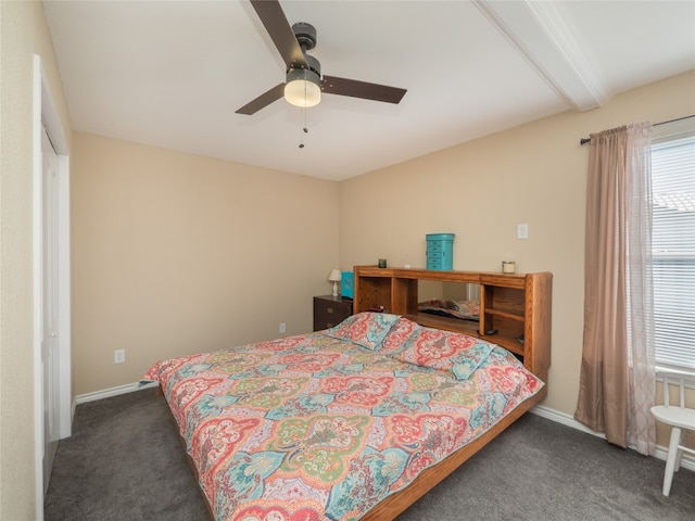 bedroom with dark colored carpet, ceiling fan, and beamed ceiling