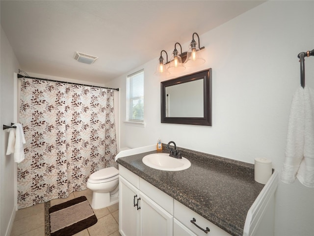 bathroom with tile patterned flooring, curtained shower, vanity, and toilet