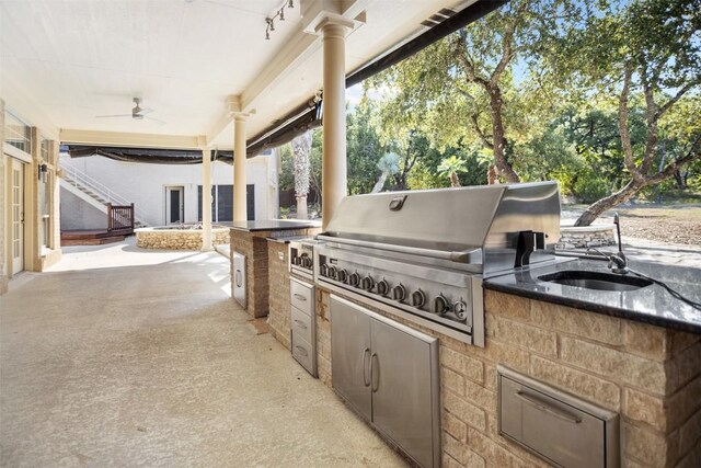 view of patio / terrace featuring area for grilling, ceiling fan, a grill, and sink