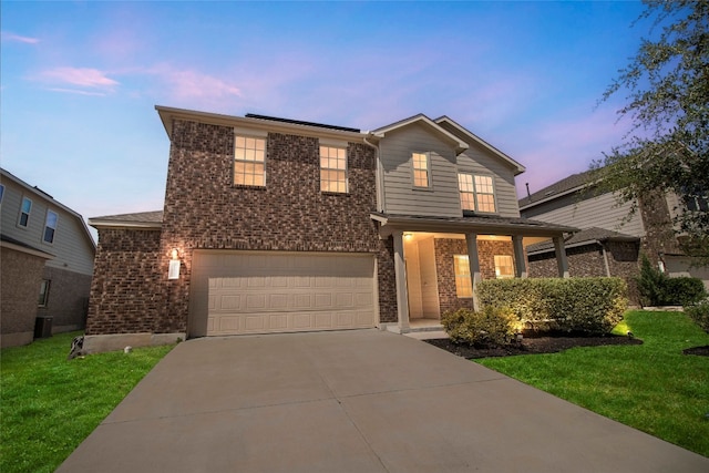 front of property featuring a yard and a garage