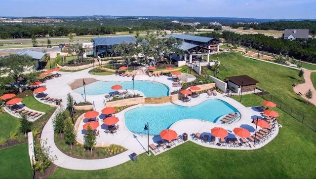 community pool featuring fence and a patio