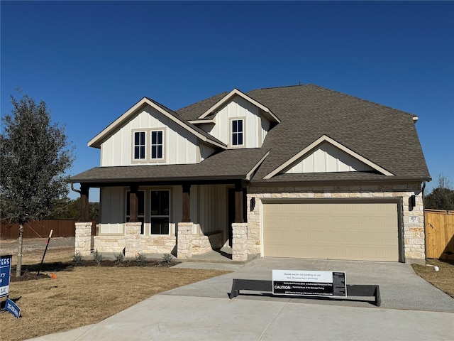 view of front of home with a garage and a porch