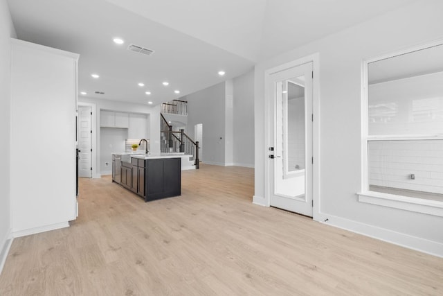 kitchen featuring light wood finished floors, visible vents, white cabinets, light countertops, and recessed lighting