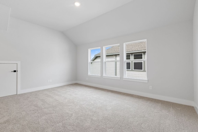 additional living space featuring vaulted ceiling, carpet floors, and baseboards