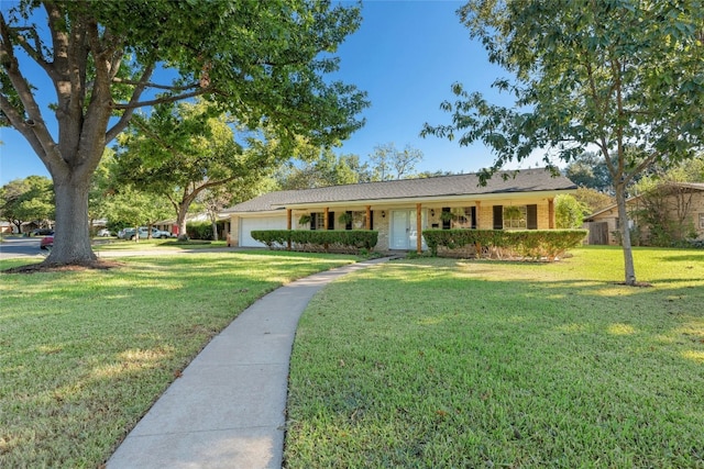 ranch-style home with a front yard and a garage