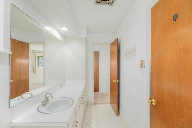 bathroom with tile patterned flooring and vanity