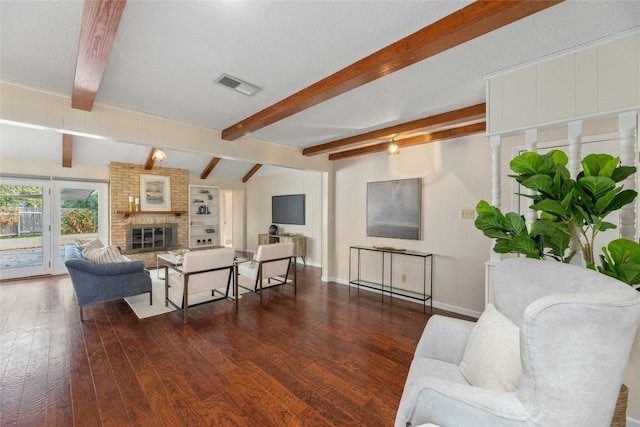 living room with a fireplace, dark hardwood / wood-style flooring, and a textured ceiling