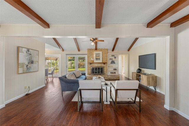 living room with a textured ceiling, lofted ceiling with beams, ceiling fan, and dark wood-type flooring