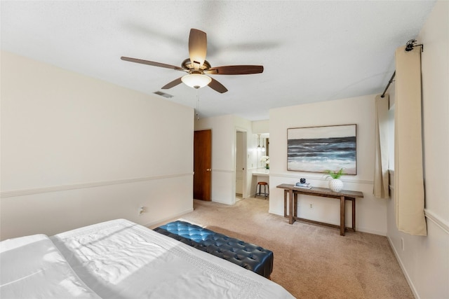 bedroom with ceiling fan and light colored carpet