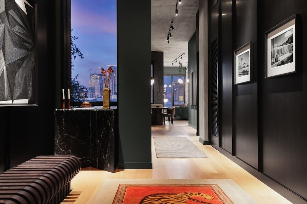 corridor featuring track lighting and wood-type flooring