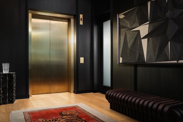 interior space with elevator and wood-type flooring