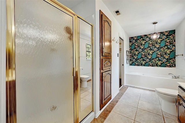 full bathroom with tile patterned floors, separate shower and tub, vanity, and toilet