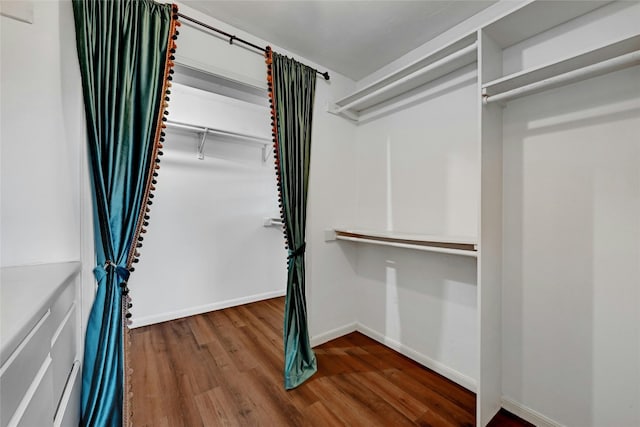 walk in closet with hardwood / wood-style floors