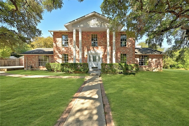 neoclassical / greek revival house with a front lawn