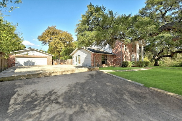 view of front of house with a garage and a front lawn