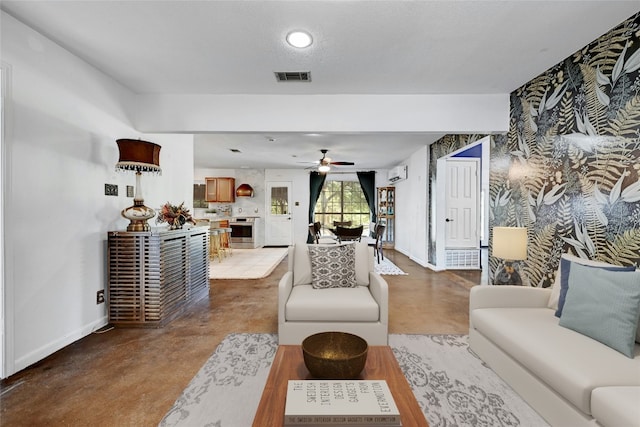 living room with ceiling fan and an AC wall unit