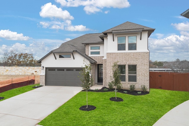 view of front of property featuring a garage and a front lawn