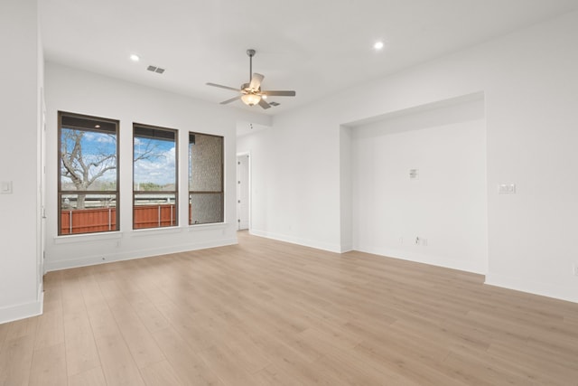 spare room with light hardwood / wood-style floors and ceiling fan