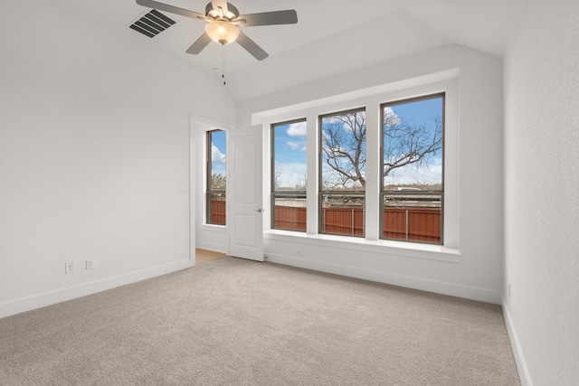 carpeted empty room featuring ceiling fan and lofted ceiling