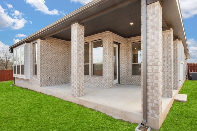 rear view of property featuring a yard and a patio