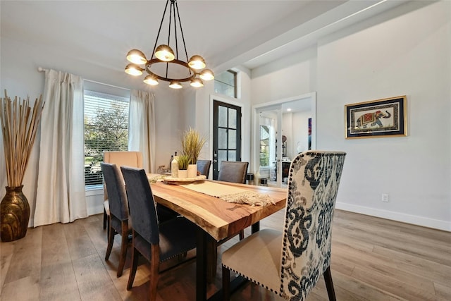 dining room featuring wood-type flooring and a chandelier