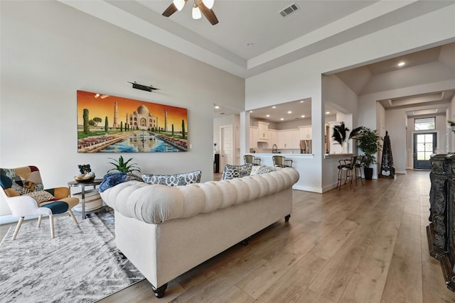 living room featuring ceiling fan and hardwood / wood-style flooring