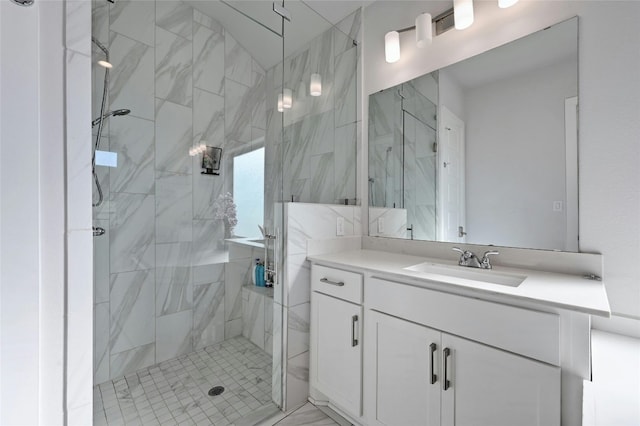 bathroom with a shower with door and vanity