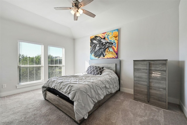 bedroom with lofted ceiling, ceiling fan, and carpet flooring