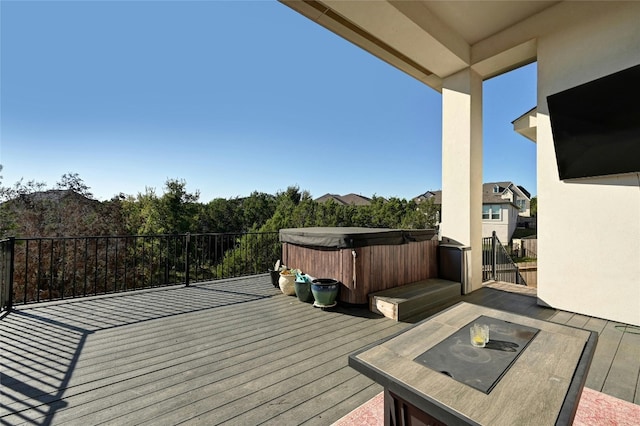 wooden terrace featuring a hot tub