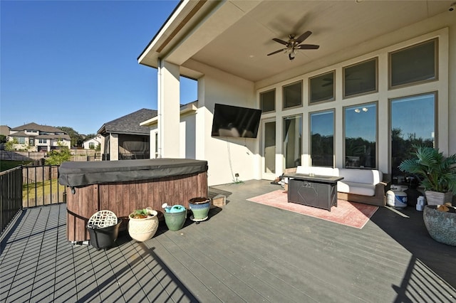 deck with ceiling fan and a hot tub