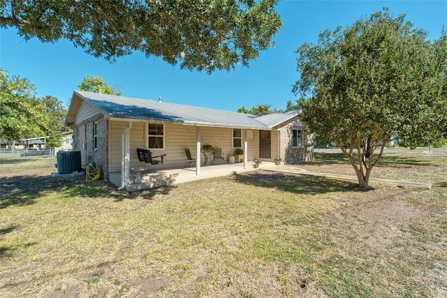 702 S Groos St, Kyle, TX 78640 - back of property with central air condition unit, a patio area, a yard, and metal roof