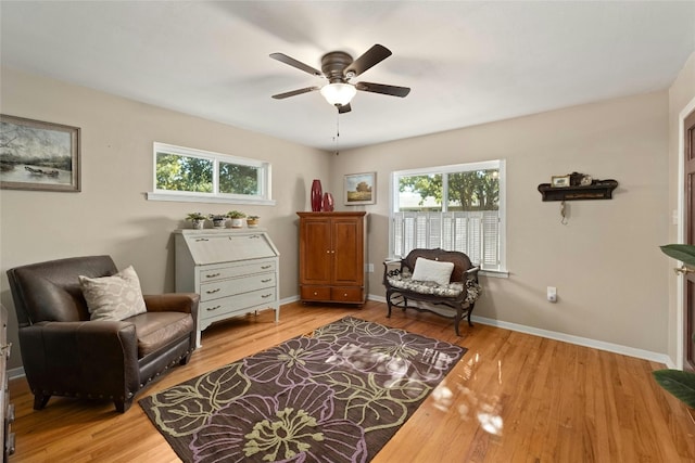 sitting room with ceiling fan and light hardwood / wood-style flooring