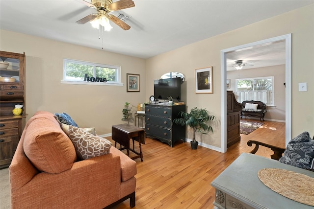 living room with light wood-type flooring and ceiling fan