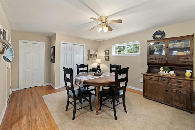 dining space featuring light wood-type flooring and ceiling fan