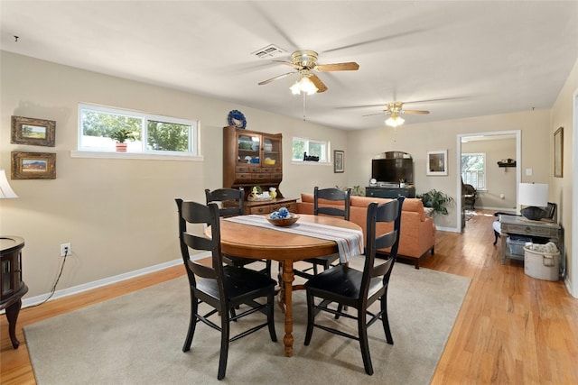 702 S Groos St, Kyle, TX 78640 - dining space with light wood finished floors, ceiling fan, and healthy amount of natural light