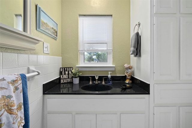 702 S Groos St, Kyle, TX 78640 - bathroom featuring a textured wall and vanity