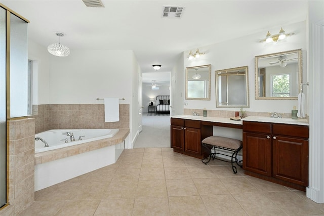 bathroom featuring vanity, tiled bath, and tile patterned floors