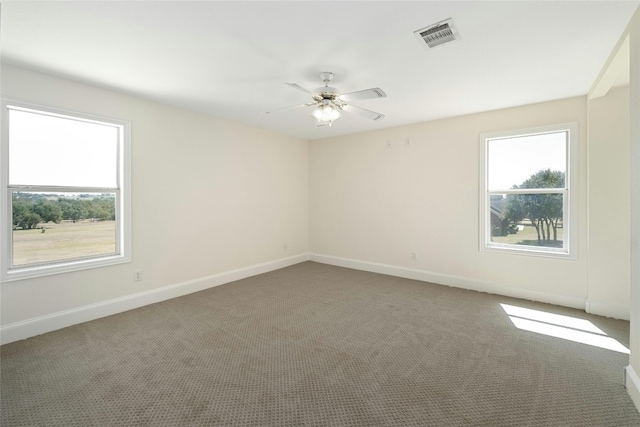 empty room featuring carpet floors and ceiling fan