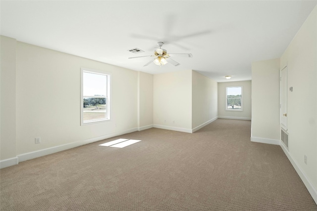 empty room featuring light carpet and ceiling fan