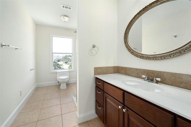 bathroom with vanity, toilet, and tile patterned flooring