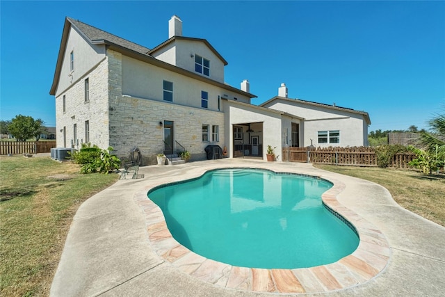 view of pool featuring a patio, central air condition unit, and a lawn