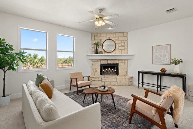 living room featuring ceiling fan, carpet flooring, and a fireplace