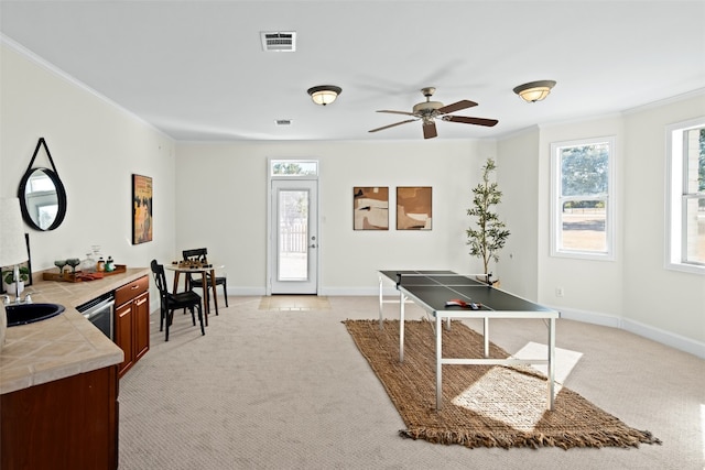 office featuring ornamental molding, sink, light carpet, and ceiling fan