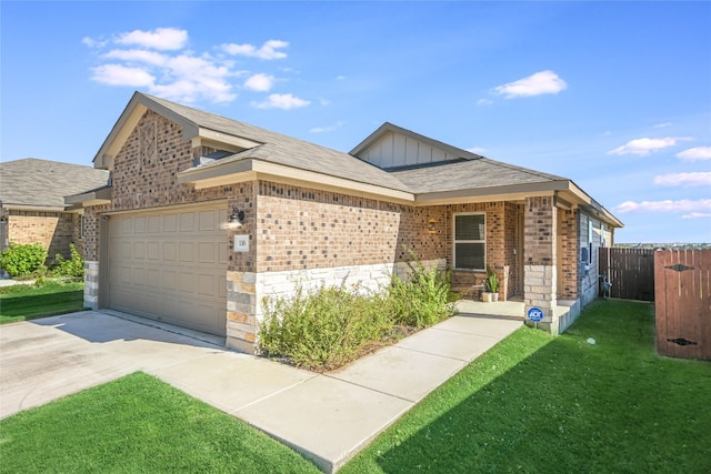 view of front of house with a front yard and a garage